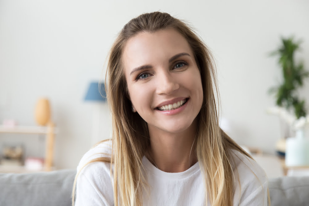 A woman with great teeth smiling - Holistic Dentistry