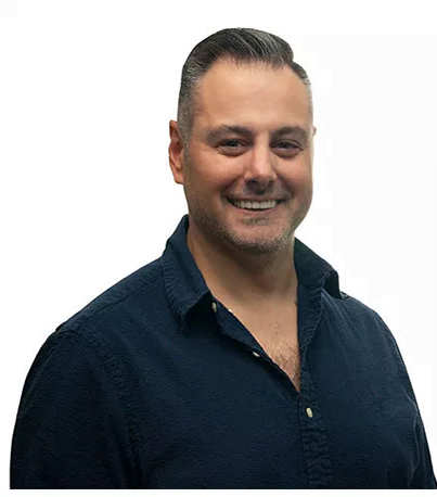 A man smiling in a dark button-up shirt - Dentist Atlanta A man smiling in a dark button-up shirt - Dentist Atlanta