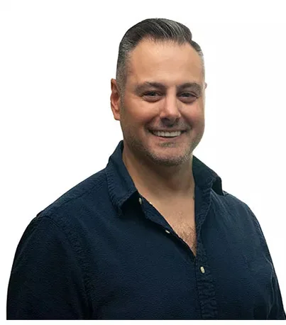 A man smiling in a dark button-up shirt - Cosmetic Dentistry Buckhead GA A man smiling in a dark button-up shirt - Cosmetic Dentistry Buckhead GA