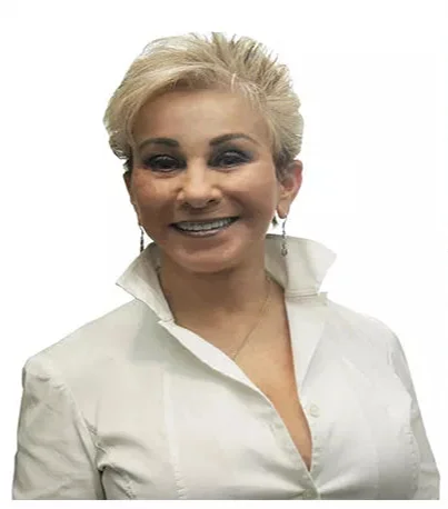 A woman smiling in a white collared shirt - Cosmetic Dentistry Buckhead GA A woman smiling in a white collared shirt - Cosmetic Dentistry Buckhead GA