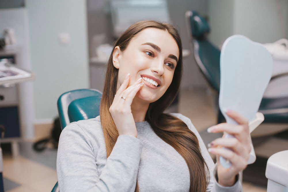 Woman checking her teeth - Dental Filling