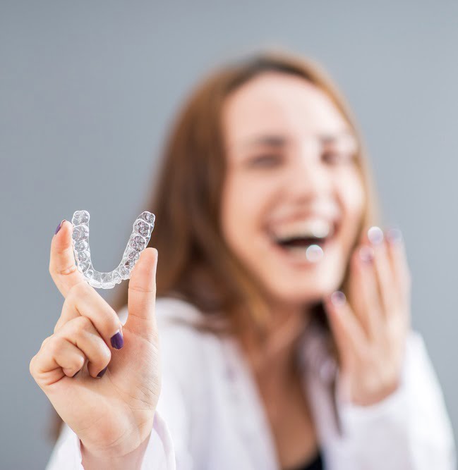 Woman holding an Invisalign
